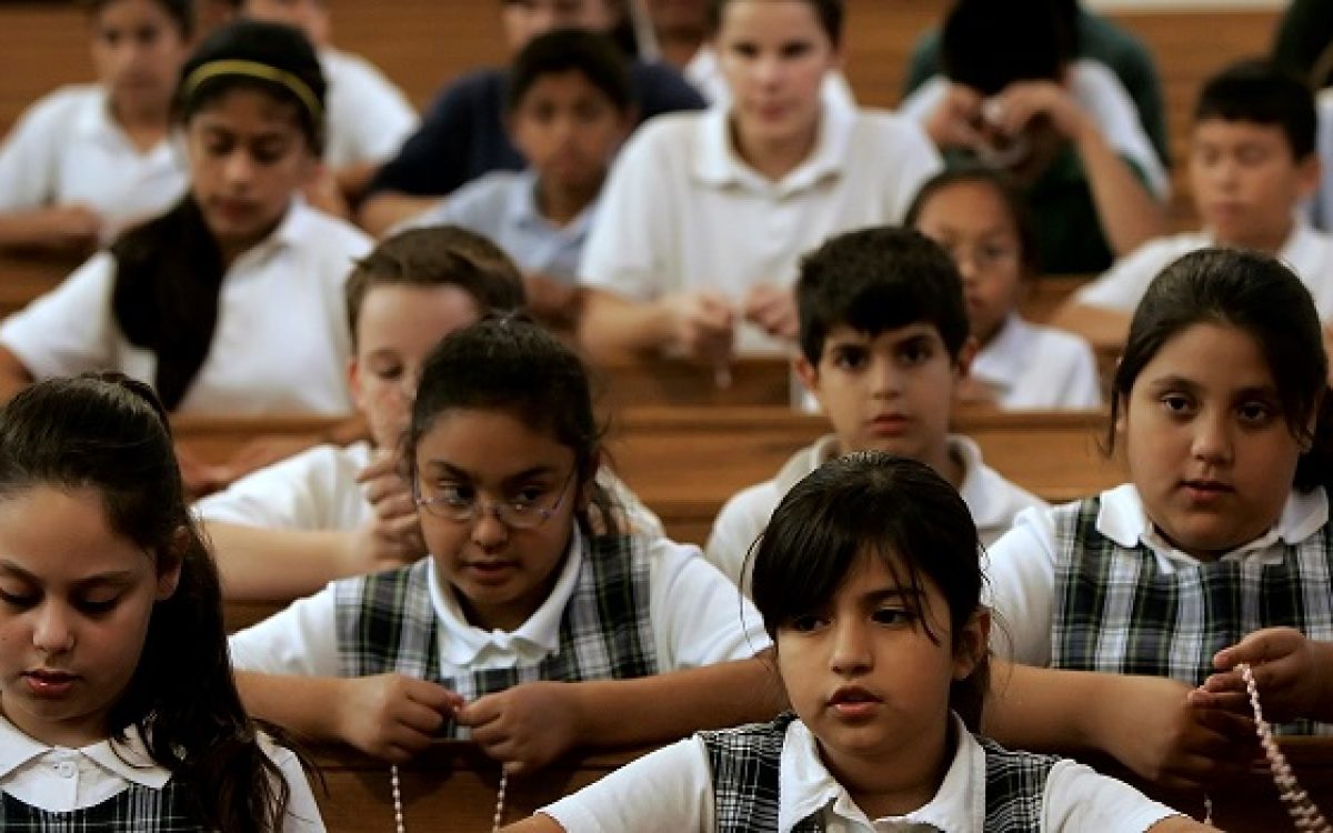 Catholic school students pray the rosary at St. Patrick's Catholic Church in Wichita, Kan., Oct. 11, 2006. About 60 percent of the parishioners at the church are Hispanic resulting in more Spanish Masses and other services geared to an immigrant population. (AP Photo/Charlie Riedel)